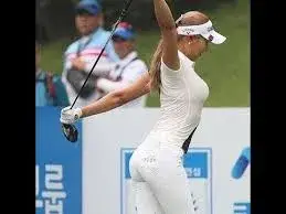 A rising star among Asian golfers a golfer in white attire stretches with a club over her shoulders on a golf course while others look on in the background envisioning the potential eruption of talent destined to shine by 