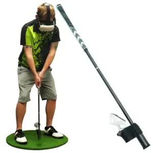 A person wearing a VR headset and holding a golf club on a small green mat demonstrating the perfect match between tech and sport A close up of the club shaft on the right showcases how golf simulators enhance your swing without stepping outside