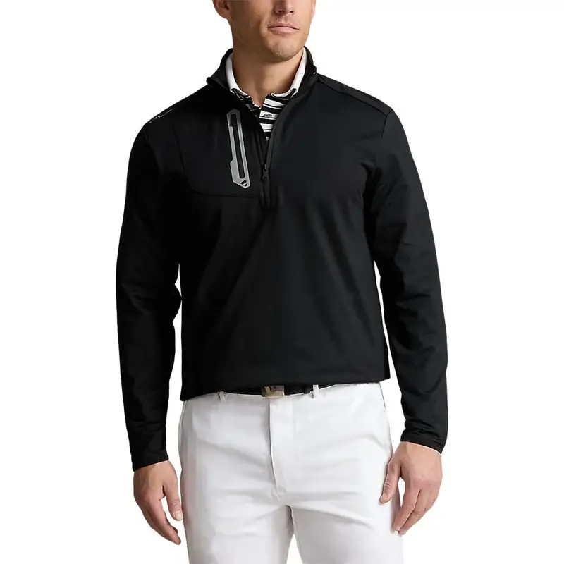 A person exudes sophistication donning a black quarter zip jacket by Peter Millar over a striped shirt and white pants standing elegantly against a plain white background