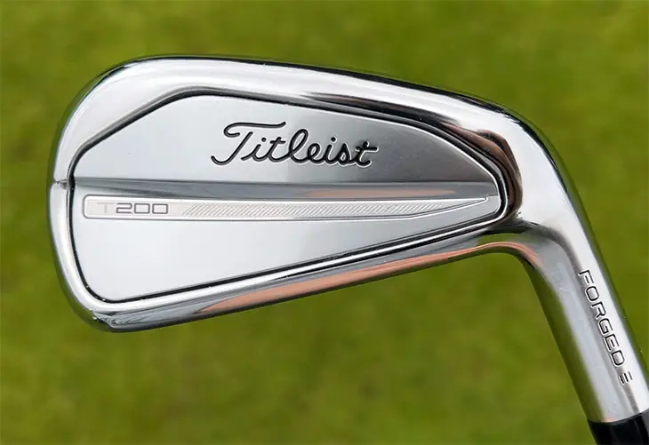 Close up of a Titleist T golf club iron from the renowned Iron Set displayed against a vibrant grassy background